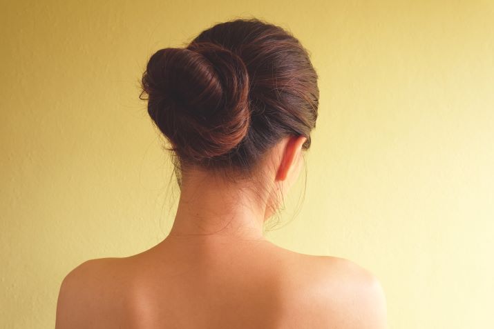 The back of a woman with a chignon hairstyle.